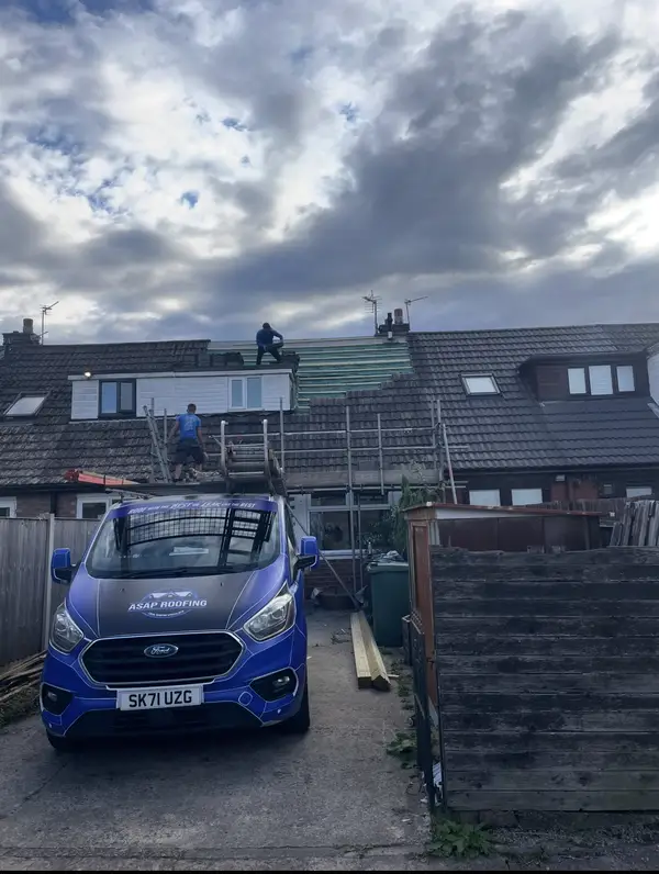 The ASAP Roofing van parked behind a terraced house during a job