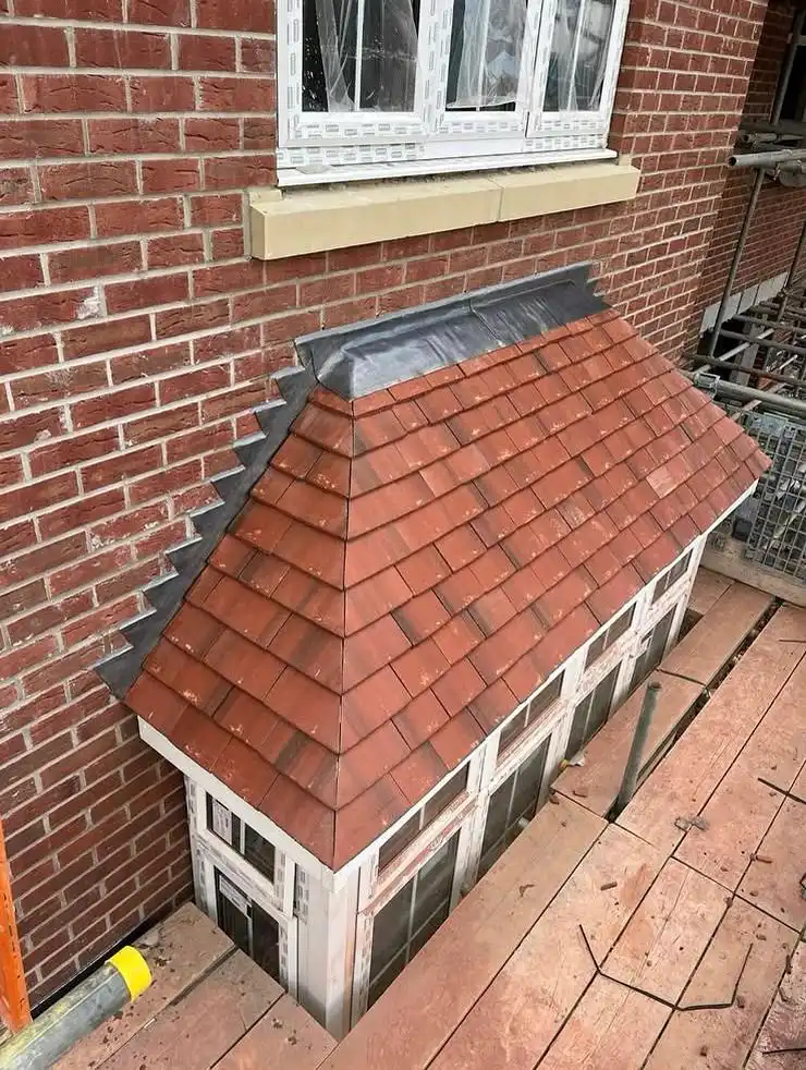 A small bay roof re-tiled in red tiles