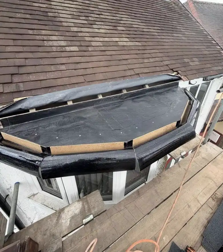 A flat roof over a bay window being re-covered